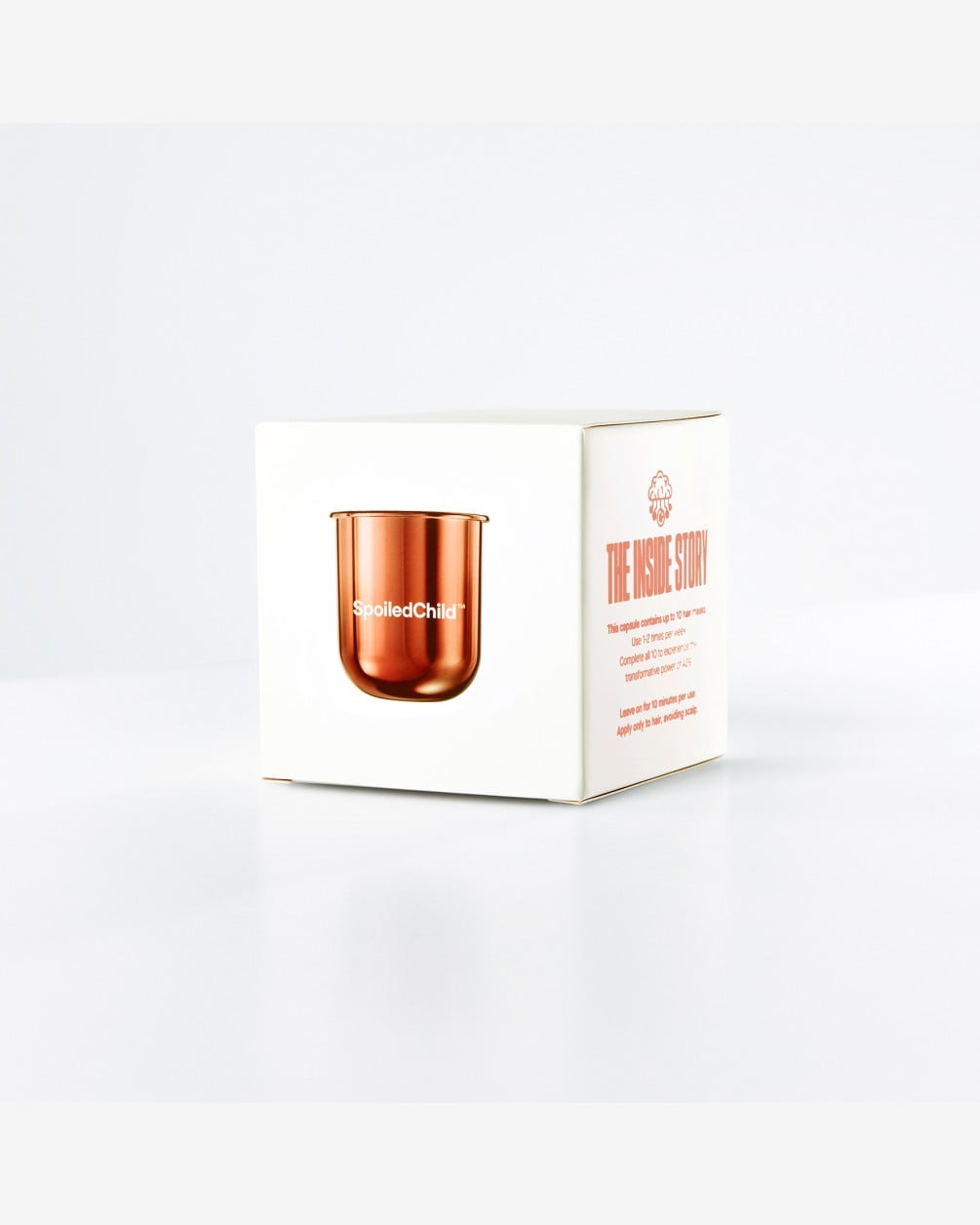 A minimalist white box for the SpoiledChild A29 Shine Activator Hair Mask. The front of the box features a product illustration of the copper-toned refill capsule, while the side panel contains detailed purple text regarding product information and usage.