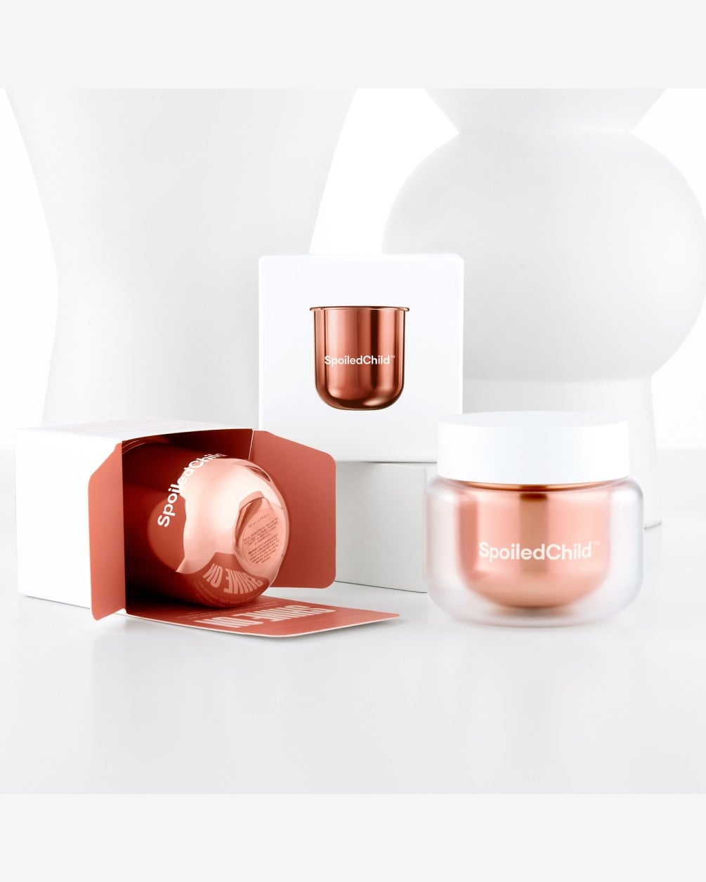 A product display for SpoiledChild A29 Shine Activator Hair Mask on a clean white background. The image includes a copper-colored glass jar with a white lid in the foreground, an open white box showing a product refill capsule.