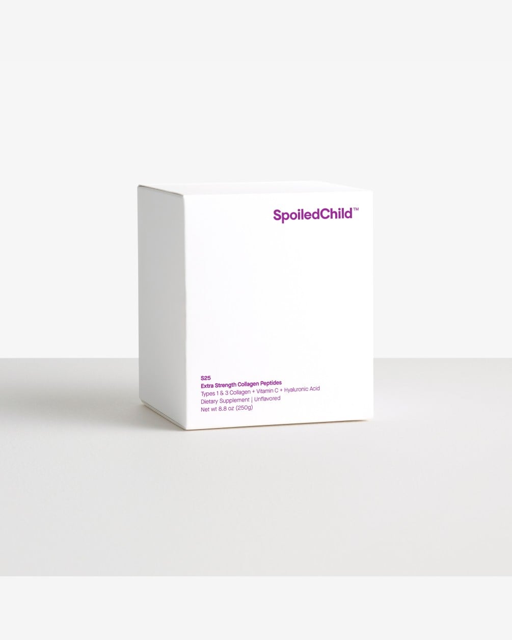 A minimalist white box for SpoiledChild S25 Extra Strength Collagen Peptides features purple text centered on its front. The box is shown against a plain white and light gray background.