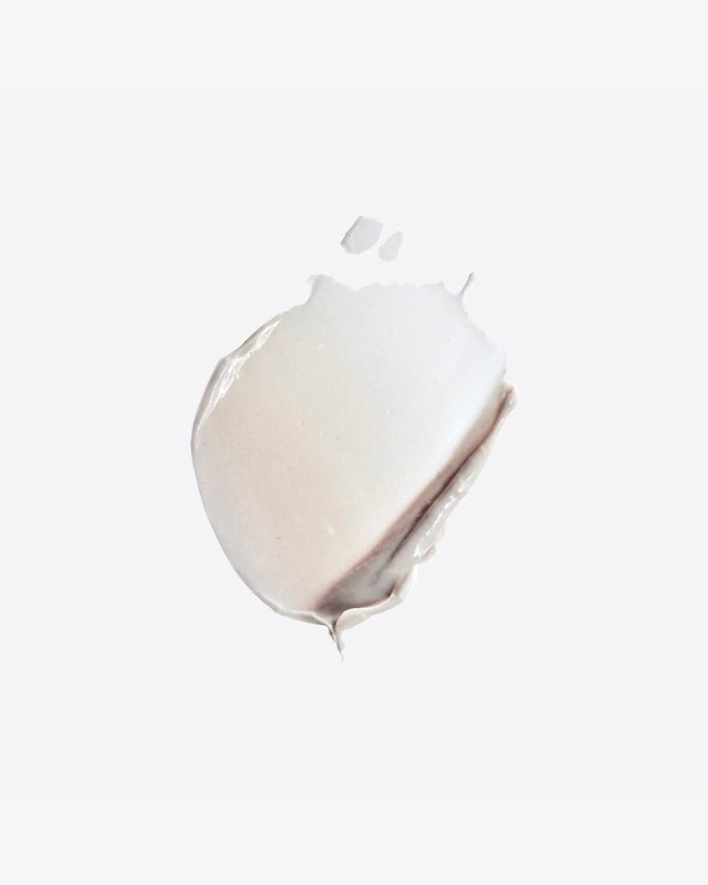 A circular smear of thick, white SpoiledChild S24 cream showing a smooth, rich texture against a plain white background.