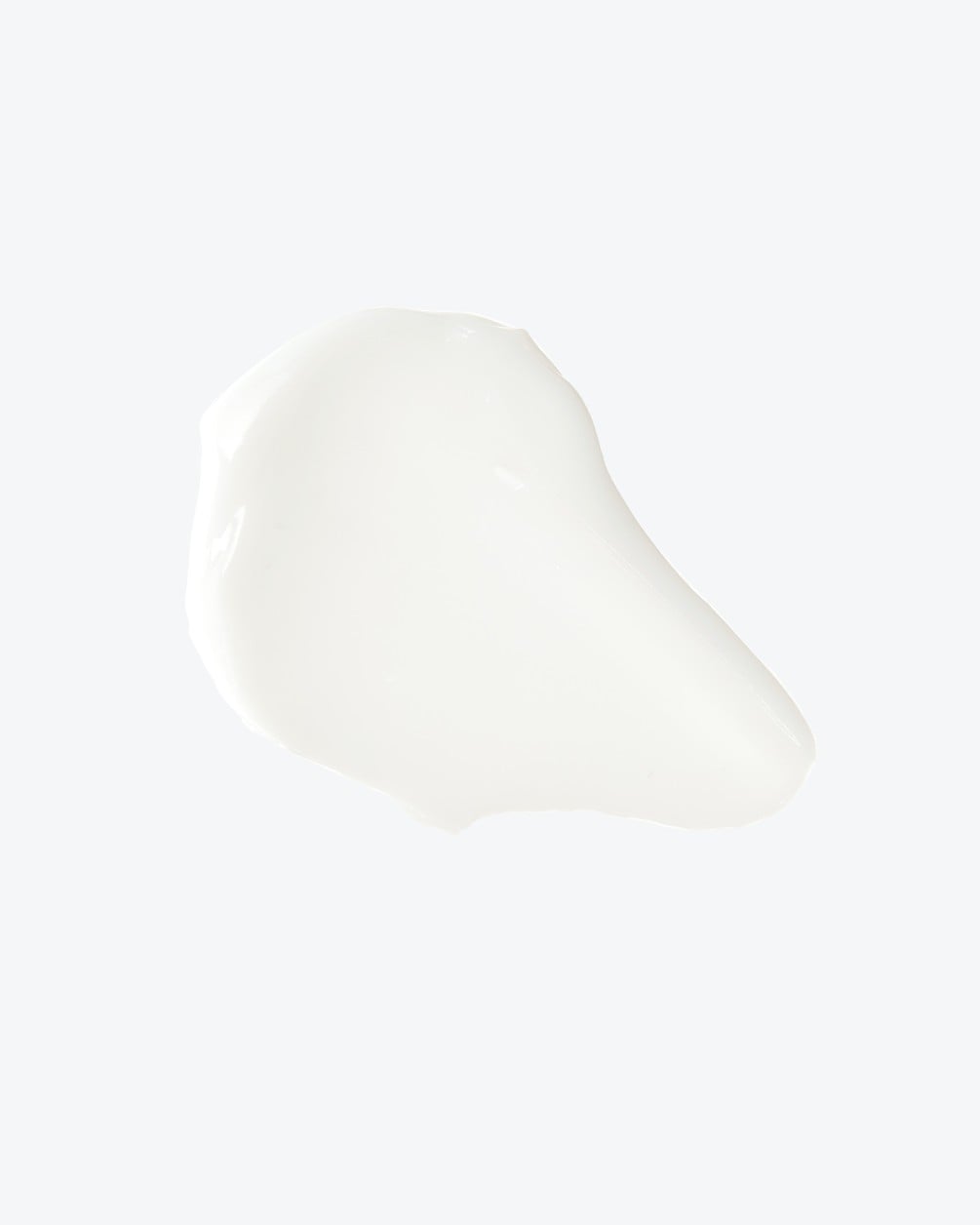 A short, smooth texture swatch of white skincare cream on a white background.